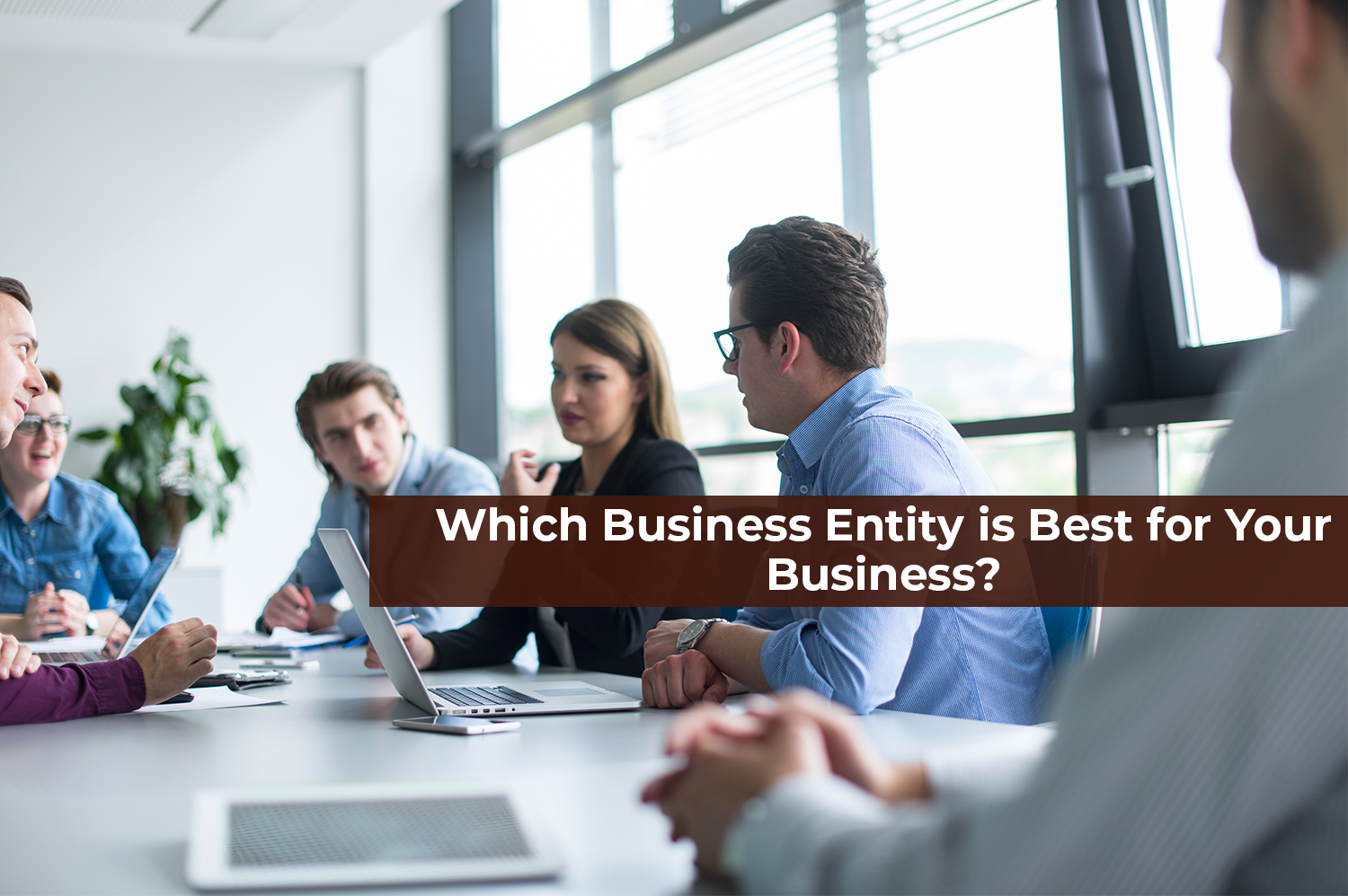 A group of people at a business meeting, trying to decide what business entity is best for their business.