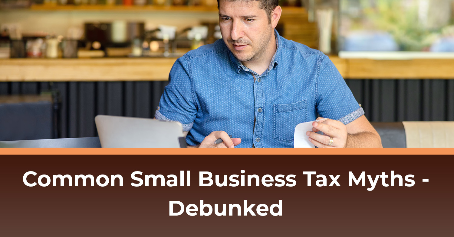 A small business owner sitting at a table taking care of his his small business tax filing.